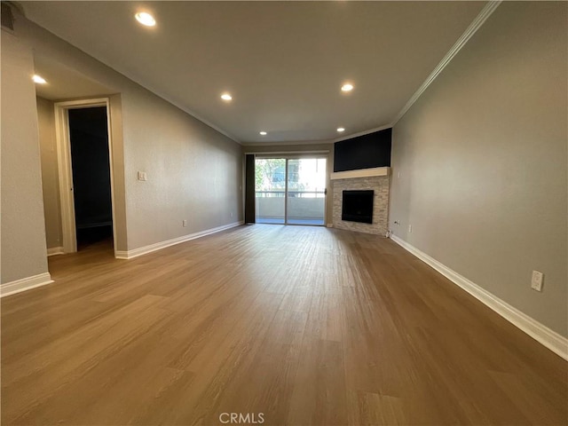 21520 Burbank Blvd Unit 116, Woodland Hills, CA 91367 - unfurnished living room featuring crown molding, wood finished floors, a fireplace, and recessed lighting