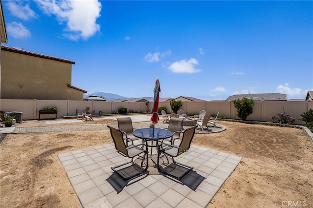 5756 Quicksilver Way, Banning, CA 92220 - fenced backyard featuring a patio, outdoor dining space, and a mountain view