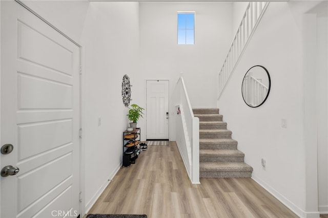 5756 Quicksilver Way, Banning, CA 92220 - foyer entrance with stairs, light wood-type flooring, and a towering ceiling