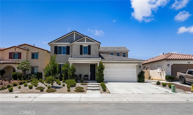 5756 Quicksilver Way, Banning, CA 92220 - view of front facade with stucco siding, a garage, driveway, and a tiled roof