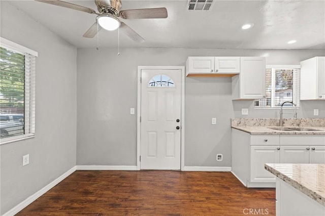 5609 Beach St, Jurupa Valley, CA 92509 - kitchen with light stone counters, healthy amount of natural light, dark wood-style floors, and recessed lighting