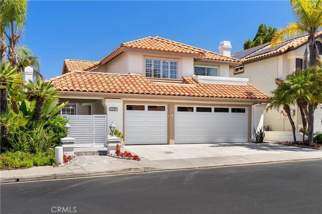 1213 Via Visalia, San Clemente, CA 92672 - mediterranean / spanish-style home with concrete driveway, a chimney, stucco siding, and a tile roof