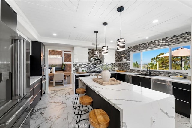 1213 Via Visalia, San Clemente, CA 92672 - kitchen featuring modern cabinets, high quality fridge, dark cabinetry, a center island, and backsplash