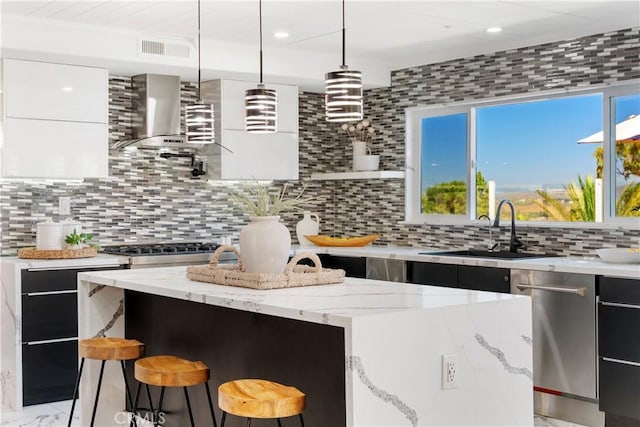1213 Via Visalia, San Clemente, CA 92672 - kitchen featuring modern cabinets, wall chimney exhaust hood, decorative backsplash, light stone countertops, and recessed lighting