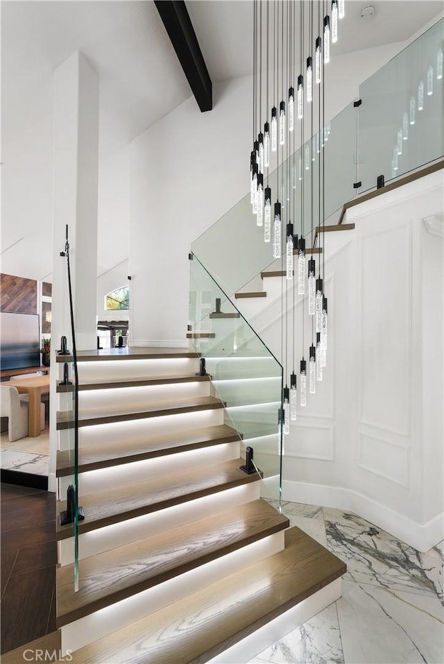 1213 Via Visalia, San Clemente, CA 92672 - stairs featuring marble tiled flooring, beam ceiling, and a high ceiling