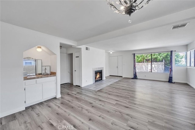 208 N Nicholson Ave Unit B, Monterey Park, CA 91755 - unfurnished living room with light wood-type flooring and a fireplace