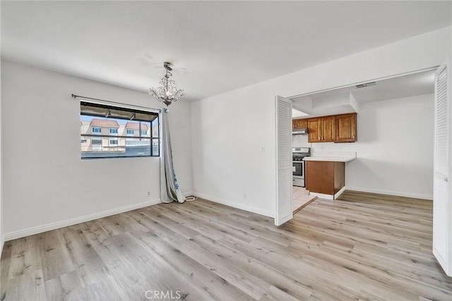 208 N Nicholson Ave Unit B, Monterey Park, CA 91755 - unfurnished living room with a chandelier and light wood-type flooring