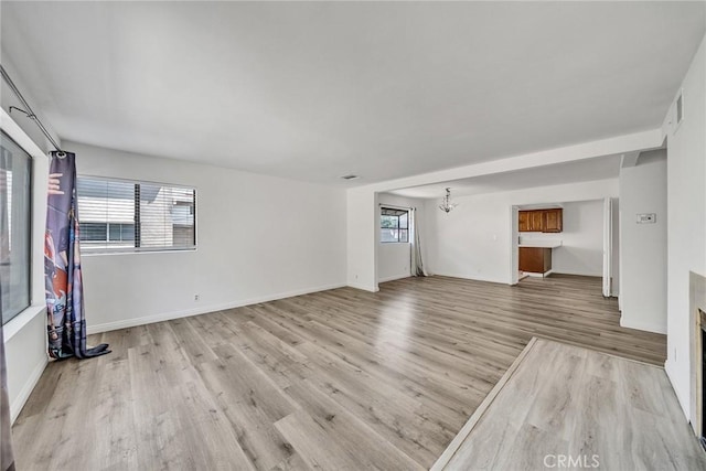 208 N Nicholson Ave Unit B, Monterey Park, CA 91755 - unfurnished living room featuring light wood-style floors and a chandelier