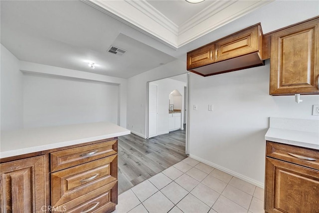 208 N Nicholson Ave Unit B, Monterey Park, CA 91755 - kitchen featuring brown cabinets, light countertops, ornamental molding, and light tile patterned flooring