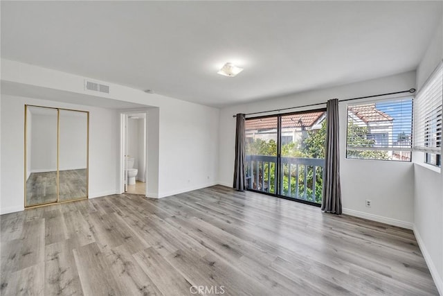 208 N Nicholson Ave Unit B, Monterey Park, CA 91755 - unfurnished bedroom featuring multiple windows, light wood-style floors, and ensuite bathroom