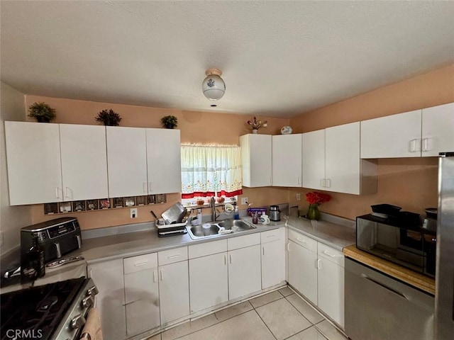 4126 Toland Way, Los Angeles, CA 90065 - kitchen featuring stainless steel appliances, white cabinetry, light countertops, and light tile patterned flooring