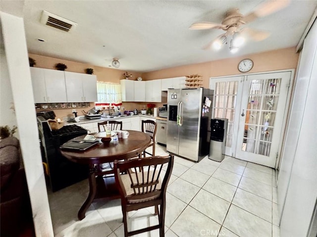 4126 Toland Way, Los Angeles, CA 90065 - kitchen featuring stainless steel appliances, ceiling fan, white cabinetry, light countertops, and light tile patterned floors