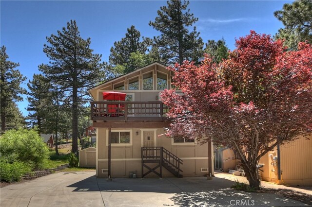 33469 Squirrel Dr, Green Valley Lake, CA 92341 - view of front of home featuring a storage unit, a balcony, and a patio