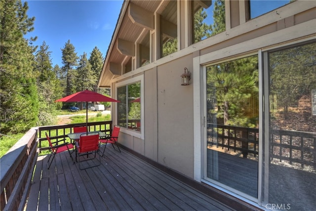 33469 Squirrel Dr, Green Valley Lake, CA 92341 - wooden deck with outdoor dining space and view of scattered trees