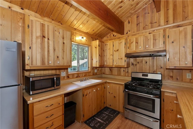 33469 Squirrel Dr, Green Valley Lake, CA 92341 - kitchen with stainless steel appliances, under cabinet range hood, light countertops, a wood ceiling with exposed beams, and light wood-type flooring