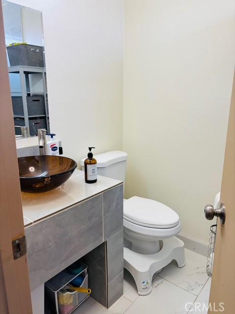 215 S 5th St, Alhambra, CA 91801 - half bathroom featuring vanity and marble look tiles