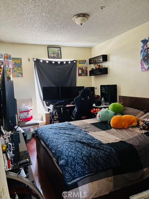 215 S 5th St, Alhambra, CA 91801 - bedroom with a textured ceiling and wood finished floors