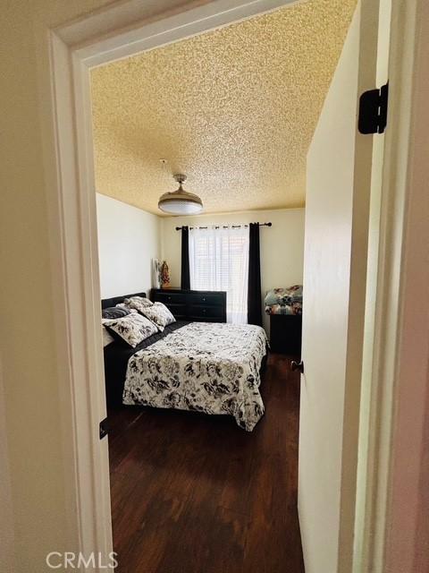 215 S 5th St, Alhambra, CA 91801 - bedroom with a textured ceiling and wood finished floors