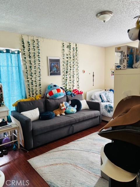 215 S 5th St, Alhambra, CA 91801 - living room with a textured ceiling and wood finished floors
