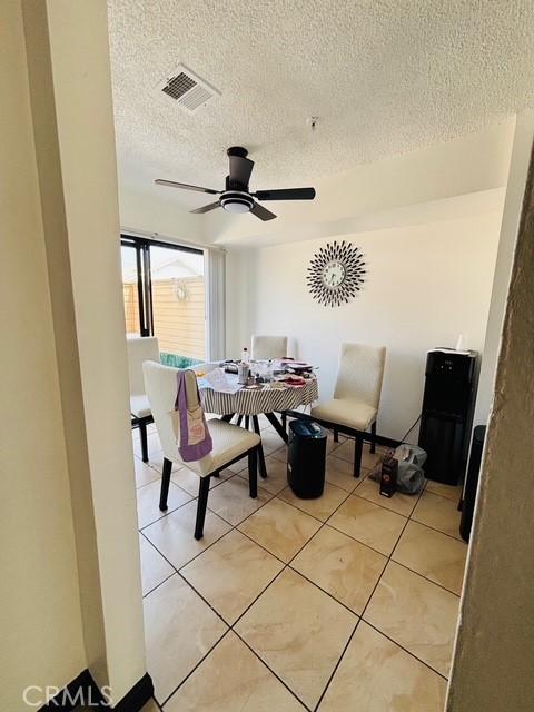 215 S 5th St, Alhambra, CA 91801 - dining area with a textured ceiling, ceiling fan, and light tile patterned flooring
