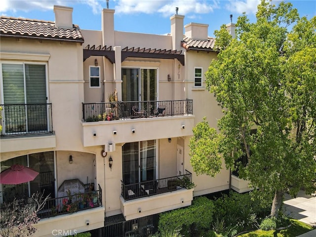 5753 White Oak Ave Unit 3, Encino, CA 91316 - back of property featuring a balcony, stucco siding, a tiled roof, and a pergola