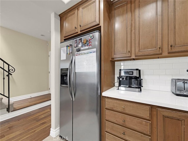 5753 White Oak Ave Unit 3, Encino, CA 91316 - kitchen with stainless steel fridge with ice dispenser, backsplash, wood finished floors, and brown cabinetry