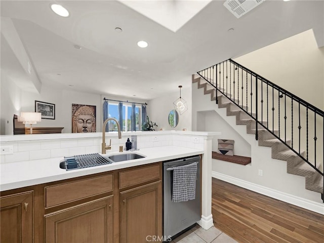 5753 White Oak Ave Unit 3, Encino, CA 91316 - kitchen with stainless steel dishwasher, light countertops, brown cabinets, recessed lighting, and light wood finished floors