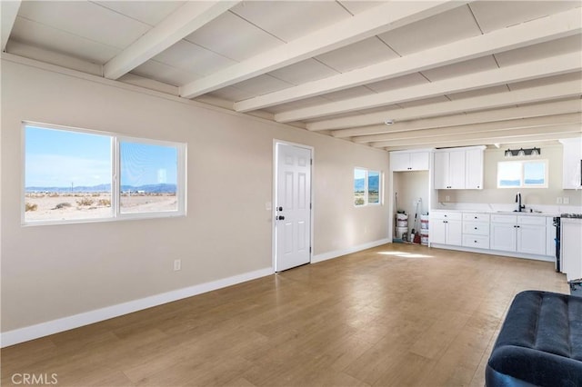 81122 Valle Vista Rd Unit 29, Palms, CA 92277 - living room with light wood finished floors and beamed ceiling