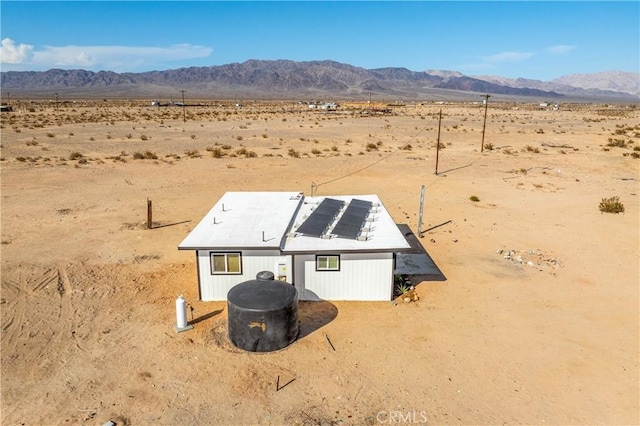 81122 Valle Vista Rd Unit 29, Palms, CA 92277 - rear view of property featuring view of desert, a mountain view, roof mounted solar panels, and a view of countryside