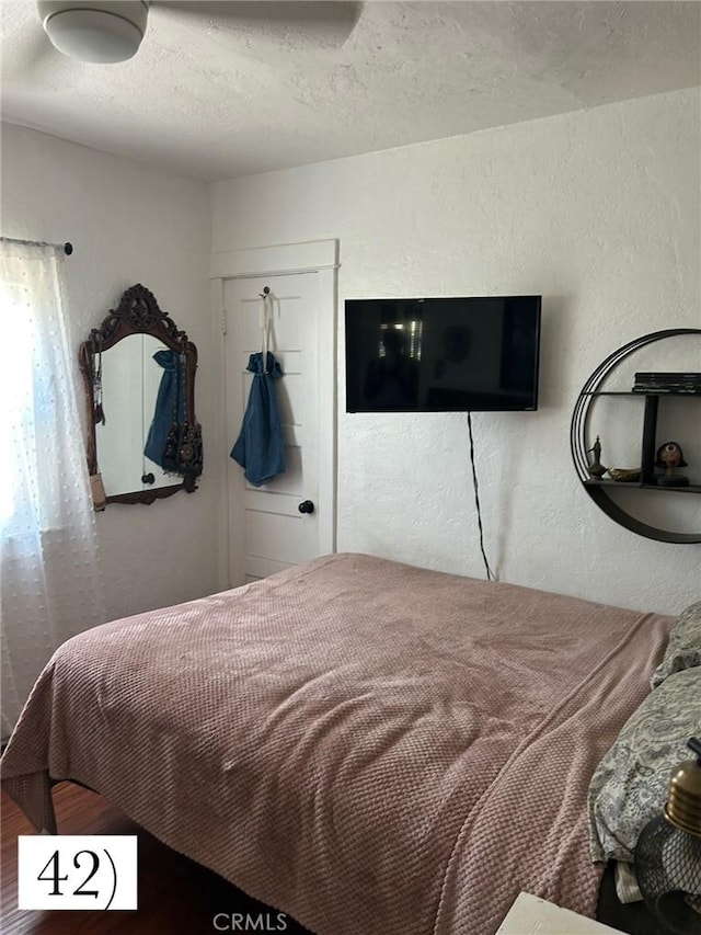 1388 N Lugo Ave, San Bernardino, CA 92404 - bedroom featuring a textured ceiling, wood finished floors, and a textured wall