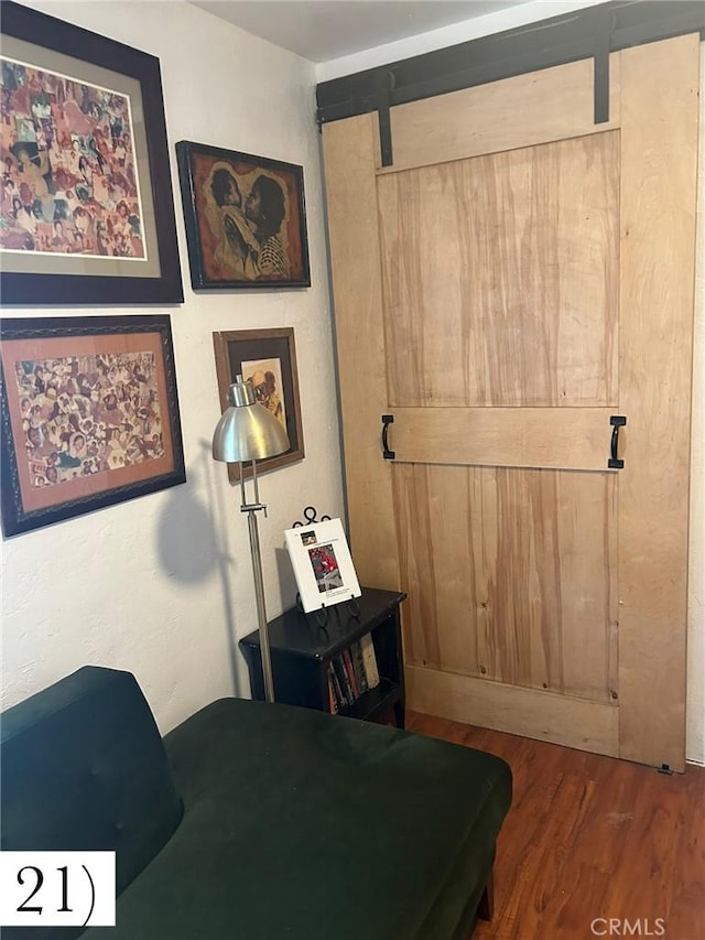 1388 N Lugo Ave, San Bernardino, CA 92404 - bedroom featuring a barn door and wood finished floors