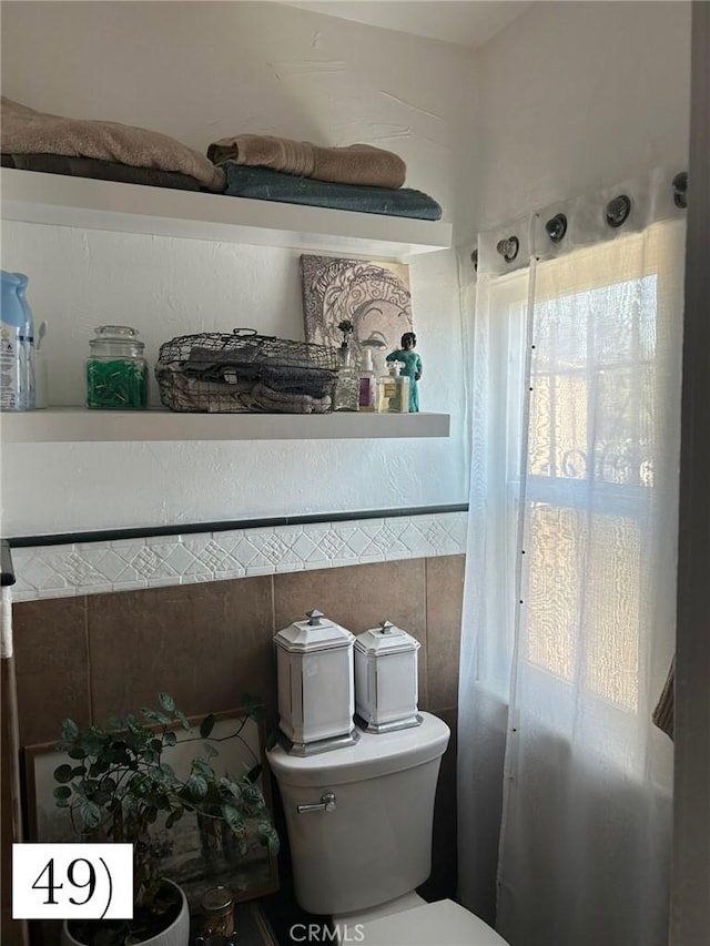 1388 N Lugo Ave, San Bernardino, CA 92404 - bathroom with toilet and tile walls