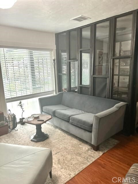 1388 N Lugo Ave, San Bernardino, CA 92404 - living room with wood finished floors and healthy amount of natural light