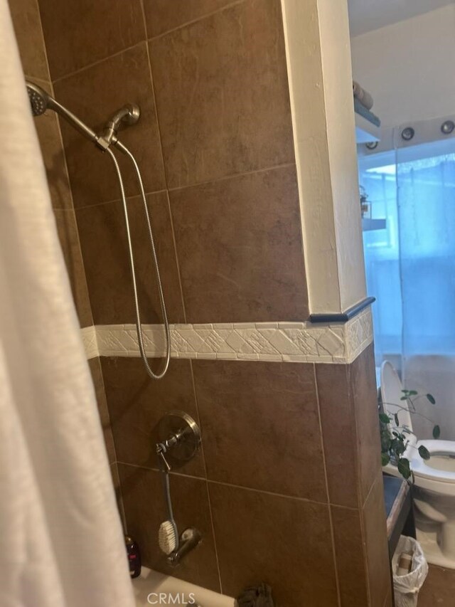 1388 N Lugo Ave, San Bernardino, CA 92404 - full bathroom with shower / bath combo with shower curtain and toilet