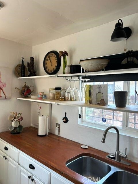 1388 N Lugo Ave, San Bernardino, CA 92404 - kitchen with butcher block counters and white cabinetry