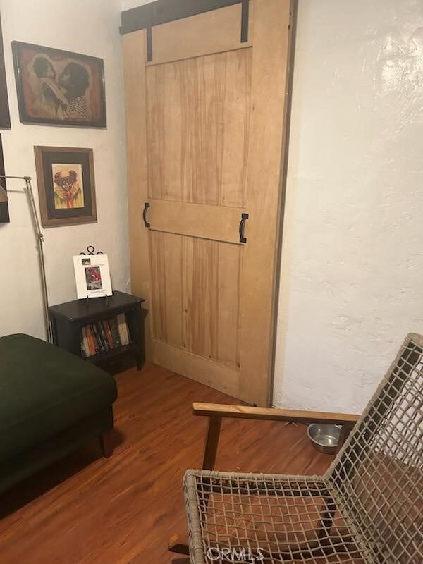 1388 N Lugo Ave, San Bernardino, CA 92404 - bedroom with wood finished floors and a barn door