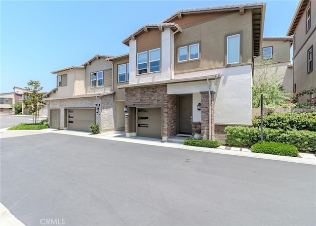 168 Denali, Lake Forest, CA 92630 - view of property featuring a garage, stucco siding, and a residential view