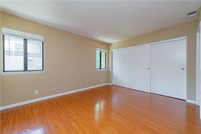 45 Willowcrest Ln, Pomona, CA 91766 - unfurnished bedroom featuring light wood-type flooring, a closet, and a textured ceiling
