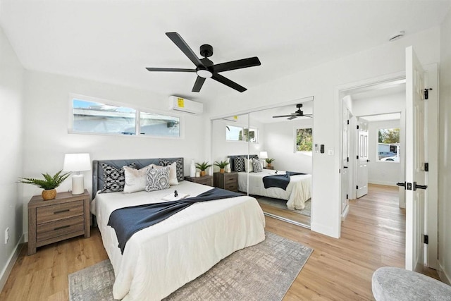 1143 Hemlock Ave, Imperial Beach, CA 91932 - bedroom featuring an AC wall unit, light wood-style flooring, a ceiling fan, and a closet