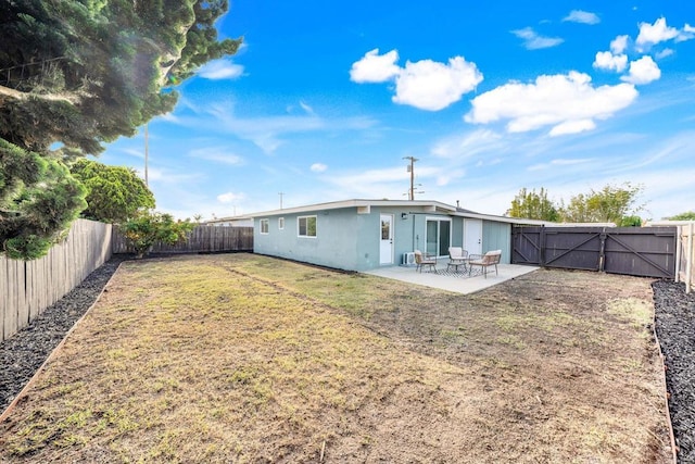 1143 Hemlock Ave, Imperial Beach, CA 91932 - back of property with a gate, a patio area, a fenced backyard, and stucco siding