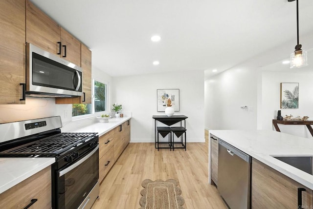 1143 Hemlock Ave, Imperial Beach, CA 91932 - kitchen with appliances with stainless steel finishes, light wood-style flooring, recessed lighting, pendant lighting, and brown cabinetry
