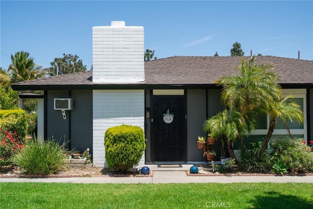 13282 Verde St, Garden Grove, CA 92844 - doorway to property with a chimney, a wall unit AC, and a shingled roof