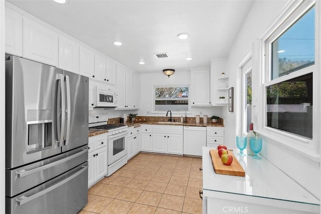 3203 Faust Ave, Long Beach, CA 90808 - kitchen featuring white appliances, plenty of natural light, white cabinets, and recessed lighting