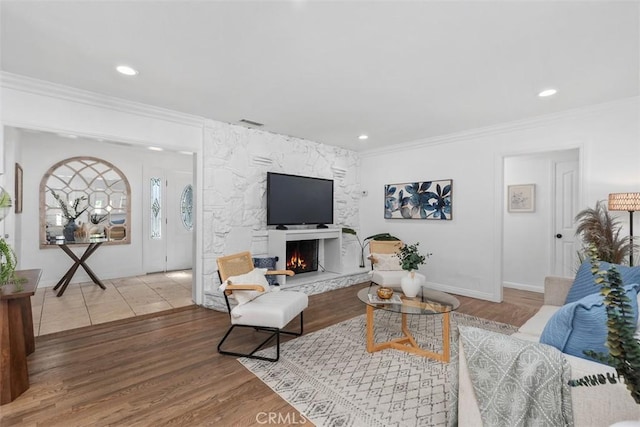 3203 Faust Ave, Long Beach, CA 90808 - living room with ornamental molding, wood finished floors, a fireplace, and recessed lighting