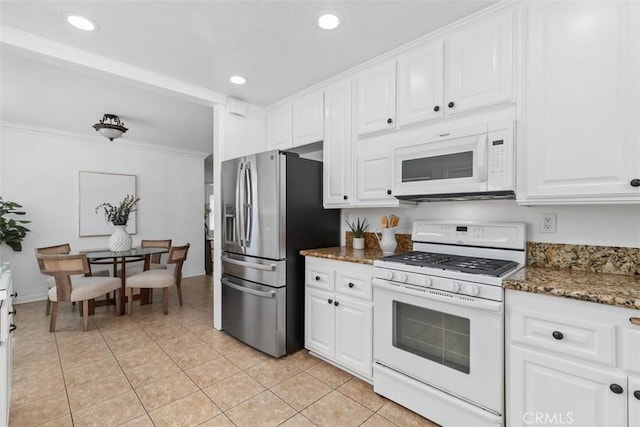 3203 Faust Ave, Long Beach, CA 90808 - kitchen with white appliances, white cabinetry, dark stone counters, light tile patterned floors, and recessed lighting