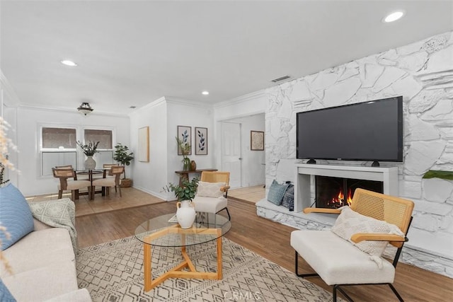 3203 Faust Ave, Long Beach, CA 90808 - living room with ornamental molding, recessed lighting, wood finished floors, and a fireplace