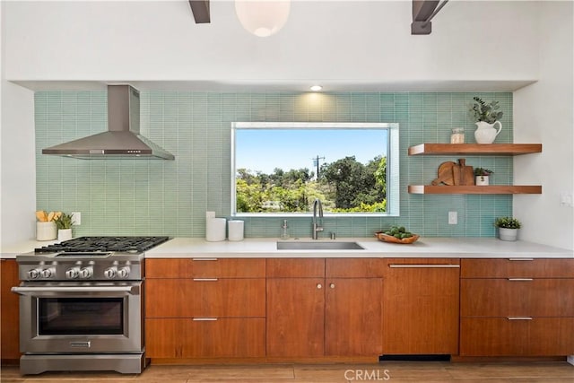 1987 Windover Rd, Pasadena, CA 91107 - kitchen featuring wall chimney range hood, stainless steel gas stove, tasteful backsplash, and light countertops
