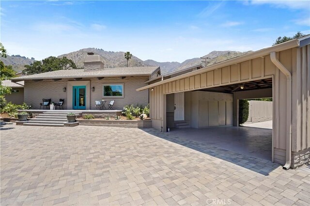 1987 Windover Rd, Pasadena, CA 91107 - view of front facade featuring a mountain view, board and batten siding, a chimney, and brick siding