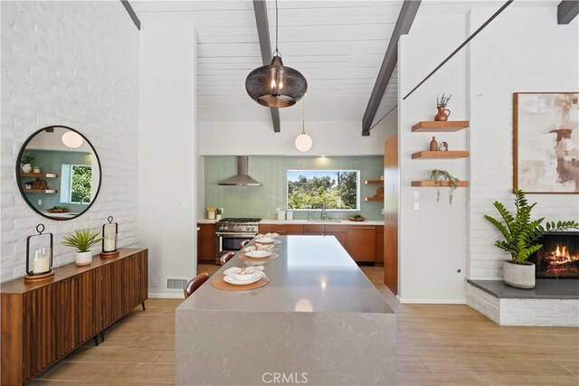 1987 Windover Rd, Pasadena, CA 91107 - kitchen featuring wall chimney range hood, high end stainless steel range, backsplash, beam ceiling, and light wood-type flooring