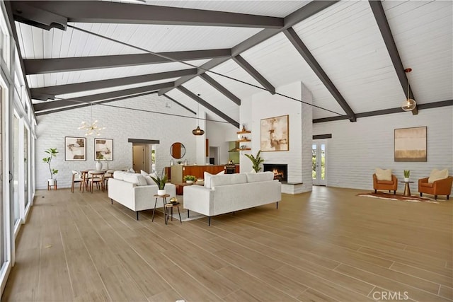 1987 Windover Rd, Pasadena, CA 91107 - living area with brick wall, a fireplace, beamed ceiling, wood finished floors, and a chandelier
